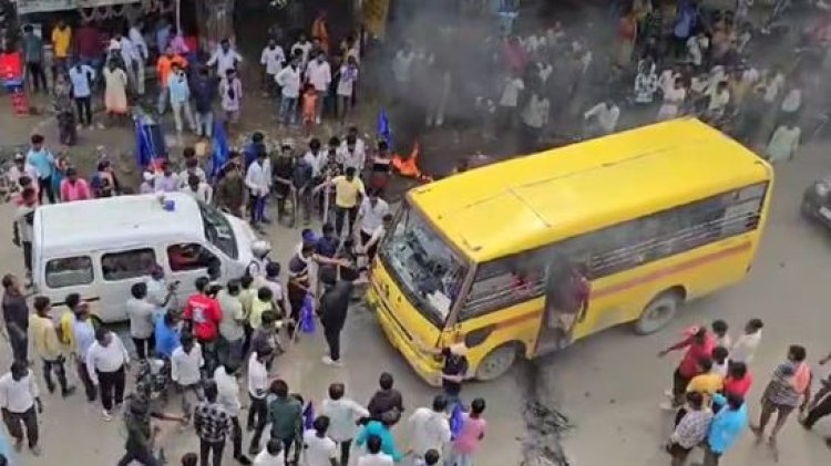 Bihar school bus carrying children drives over a burning tire as a mob blocks the road during Bharat Bandh.